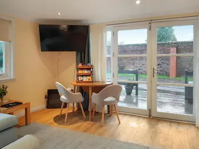 a living room with a table and chairs and a window at Leven Lodge 1 - Uk46042 in Balloch