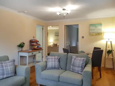 a living room with a couch and a table at Leven Lodge 2 - Uk46044 in Balloch
