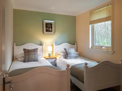 two beds in a small bedroom with a window at Leven Lodge 2 - Uk46044 in Balloch