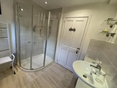 a bathroom with a shower and a sink at The Cottage, overlooking Loch Fyne in Cairndow