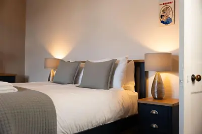 a bedroom with a bed with two lamps on it at Saskatchewan House in Oban