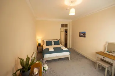 a bedroom with a bed and a television in it at Saskatchewan House in Oban