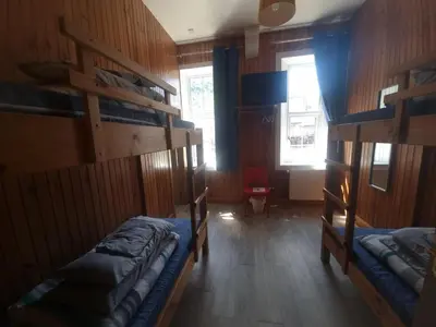 a room with two bunk beds and a window at Blackwater Hostel in Kinlochleven