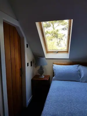 a bedroom with a bed and a window at Station House Lanark Bed and Breakfast in Lanark