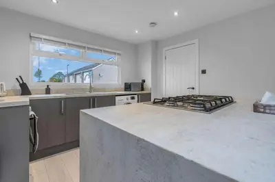a kitchen with a large counter top in a room at West Lothian 5 Beds + car space in Whitburn
