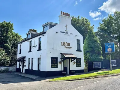 a white building on the corner of a street at The Shore in Gourock