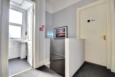 a hallway with a refrigerator and a window at The Cloch in Gourock