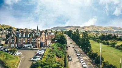 a city with cars parked in a parking lot at Braid Hills Hotel in Edinburgh