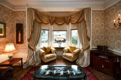 a living room with two chairs and a large window at The Townhouse Ayr - Luxury B&B - adults only in Ayr