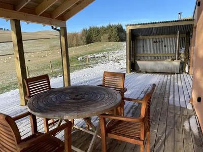 a wooden table and chairs on a wooden deck at Townhead in Peebles