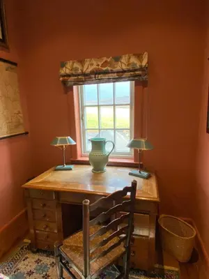 a room with a desk with two lamps and a window at Townhead in Peebles