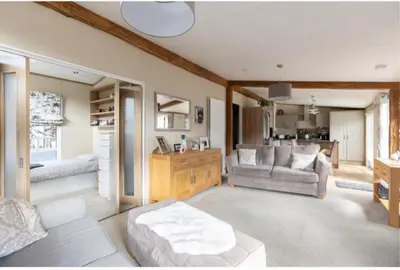 a living room with a couch and a table at Loubet Extra Large Lodge in Auchterarder