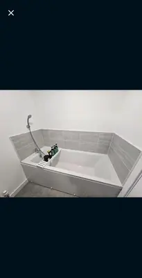 a white bath tub with a sink in a room at Darnley southside room in a private home 61 Leggastston Road in Pollokshaws