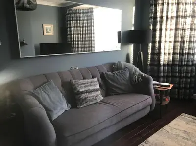 a gray couch with pillows in a living room at Ultra Stylish furnished Home in Edinburgh in Edinburgh
