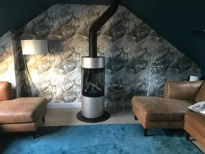 a fireplace in a living room with a stone wall at Ultra Stylish furnished Home in Edinburgh in Edinburgh