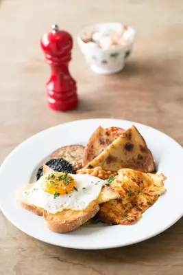 a plate of food with eggs on top of toast at MHOR 84 in Kingshouse