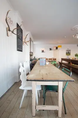 a wooden table in a room with chairs and a table at MHOR 84 in Kingshouse