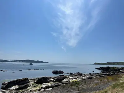 a large body of water with rocks in it at Millport Beach Apartment, Crichton St, sea views in Millport