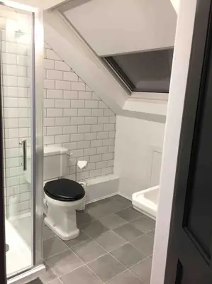 a bathroom with a toilet with a black seat at Tarbert large, bright, 4 bedroom flat with harbour views in Tarbert