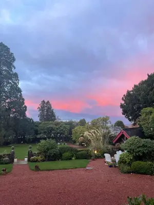 a view of a garden with a sunset in the background at Moorlands in Helensburgh