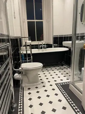 a bathroom with a tub and a toilet and a sink at Moorlands in Helensburgh