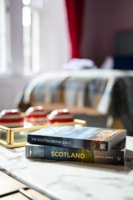 two books sitting on top of a table at Queen Charlotte Guesthouse in Edinburgh