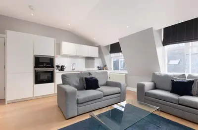 a living room with two couches and a glass table at Destiny Scotland - Hill Street Apartments in Edinburgh