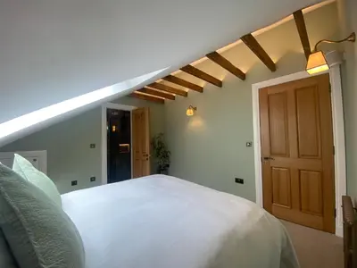 a bedroom with a white bed and a wooden door at Ashton View in Glasgow
