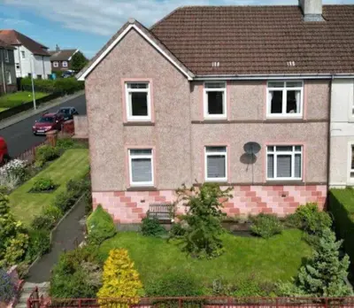 a brick house with a grassy yard at Springfield Apartment - Train to Glasgow or Edinburgh - Private Parking & Wifi in Airdrie