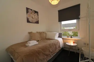 a bedroom with a bed with two pillows on it at Signature - Belvidere House in Glasgow