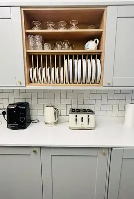 a kitchen with white cabinets and a counter with utensils at Glasgow Center/West End Apartment in Glasgow