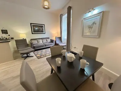 a living room with a table and chairs and a couch at King’s stable 2 rooms in Edinburgh
