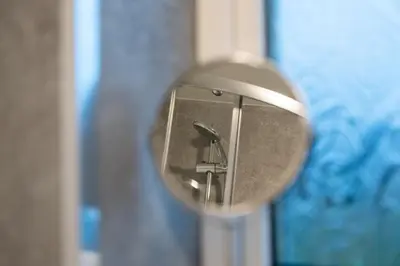a close up of a mirror with a reflection of a person at 2 BDR Apt By Caledonia Luxe Stays Short Lets & Serviced Accommodation Bishopton in Bishopton