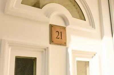 a door with a clock on the wall at Charming 2BD House - Parking & Garden in Oban in Oban