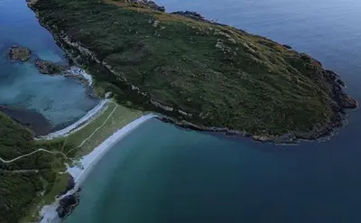 an island in the ocean next to a body of water at ISLE OF GIGHA FARM HOUSE in Isle of Gigha