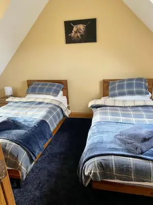 two beds sitting next to each other in a bedroom at Scottish Highland house Fort William in Corran