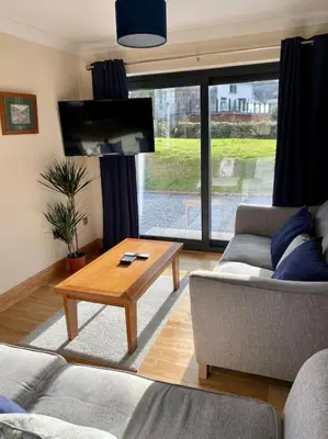 a living room with a couch and a coffee table at Scottish Highland house Fort William in Corran