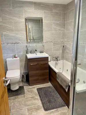 a bathroom with a toilet and a sink and a tub at Scottish Highland house Fort William in Corran