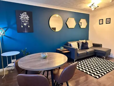 a living room with a couch and a table at BrightCentral Apartment With Parking in Glasgow