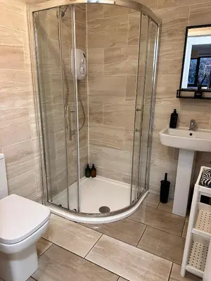a bathroom with a shower and a toilet and a sink at BrightCentral Apartment With Parking in Glasgow