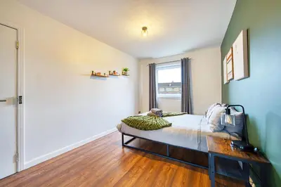 a bedroom with a bed and a window at New Slick Finnieston Pad w/ Free Parking in Glasgow