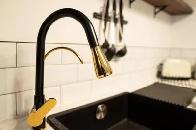 a kitchen sink with a faucet on a counter at Stylish City Pad with Free Private Parking in Glasgow