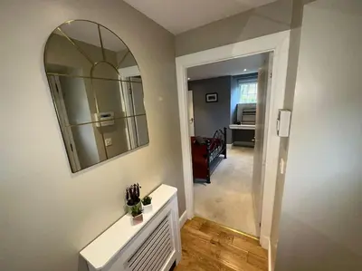 a living room with a mirror on the wall at The Gate House - 3 Bed & Parking in Edinburgh