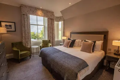 a bedroom with a large bed and a window at Crieff Hydro in Crieff