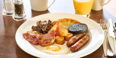 a plate of breakfast food on a wooden table at Crieff Hydro in Crieff