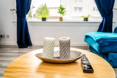 a table with two candles on top of it at Sleek and Stylish 3 Bed in Greenock - Sleeps 8 in Greenock