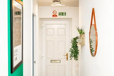 a hallway with a white door and a mirror at Sleek and Stylish 3 Bed in Greenock - Sleeps 8 in Greenock