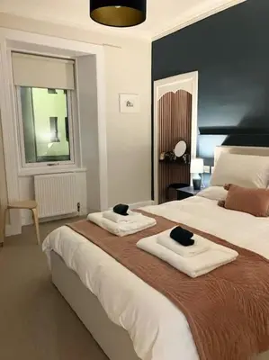 a bedroom with two beds with towels on them at Waverley Apartments, The Wheelhouse in Gourock