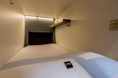 a small room with a bed with a sign on it at CODE - The Loft, Edinburgh in Edinburgh