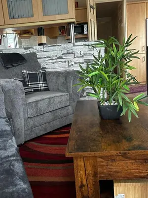 a living room with a couch and a coffee table at Bay 1 in Kirkcolm
